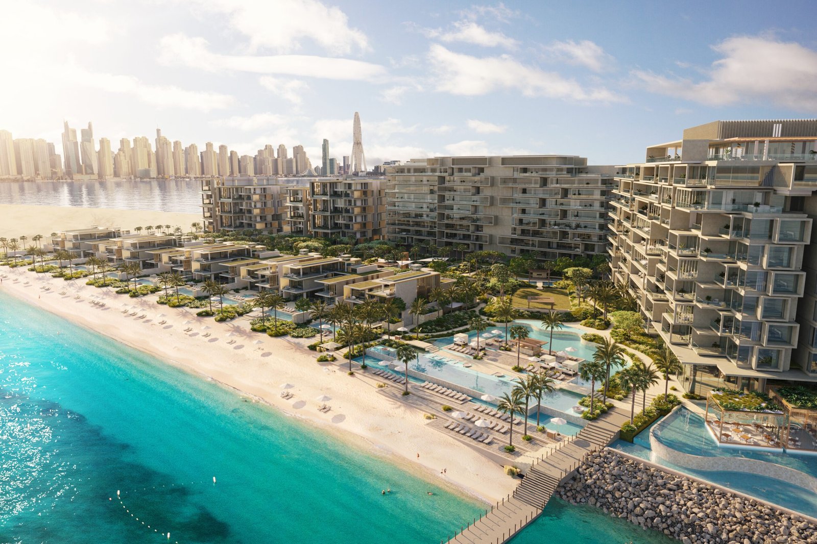 Vista aérea de resort à beira-mar, com praia, piscinas e prédios baixos diante da orla de Dubai
