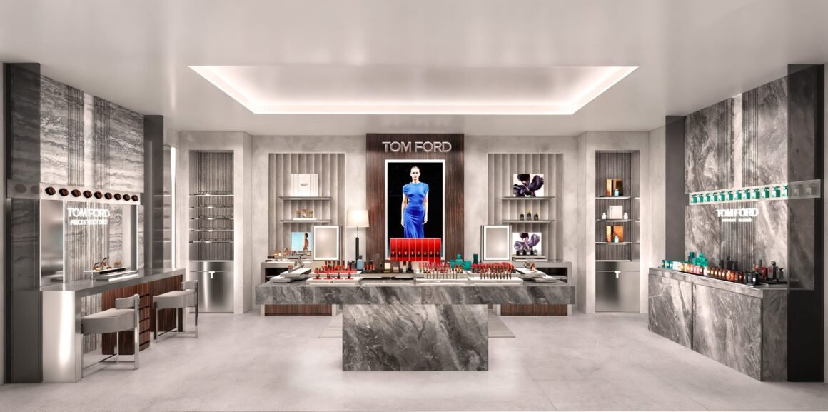 Projeção do interior da flagship Tom Ford Beauty, com balcão central de mármore cinza, painel de madeira escura e displays de maquiagem e fragrâncias