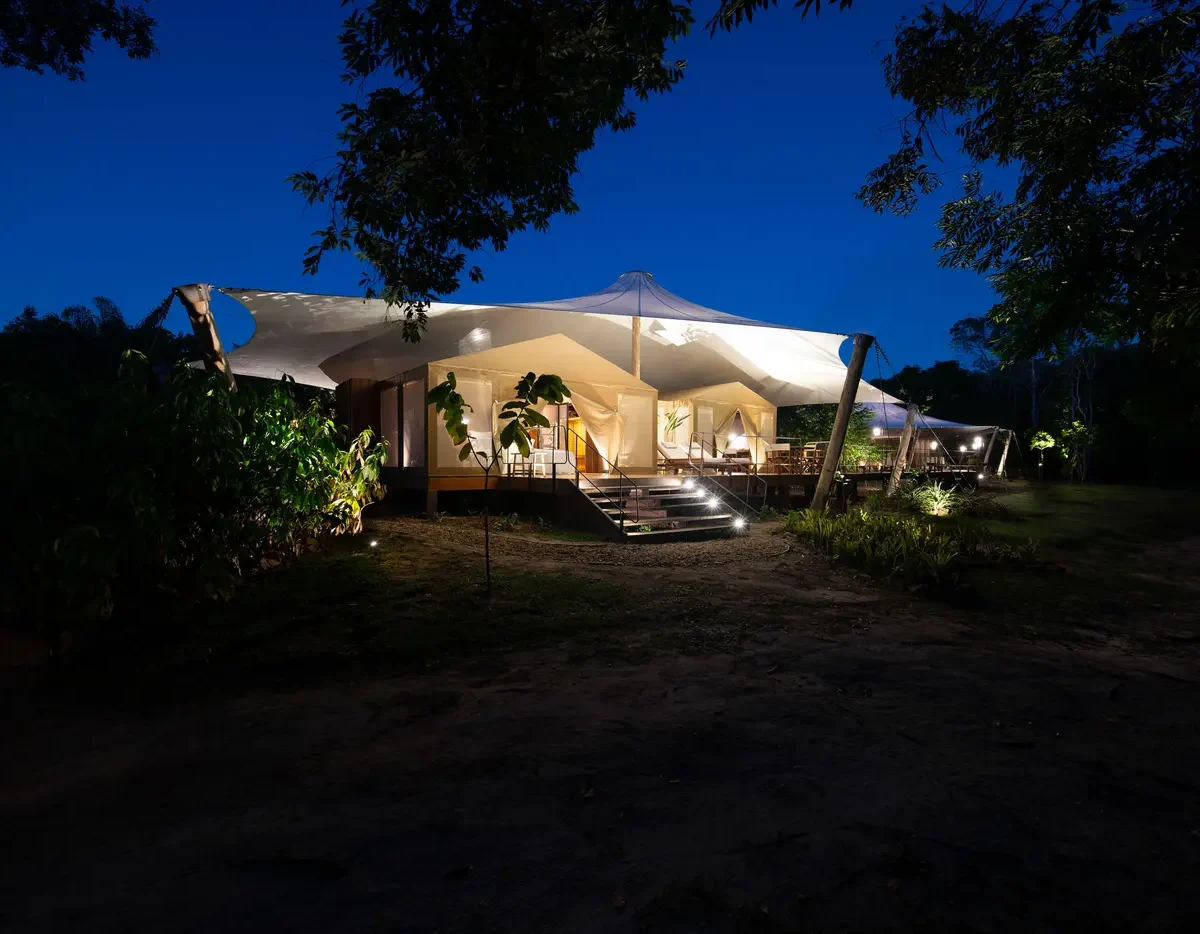 Cristalino Camp tented suite lit at night in the Amazon forest