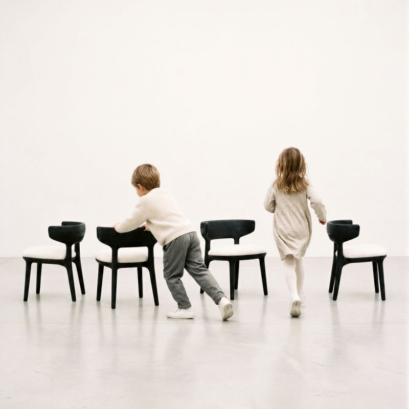 Two children playing among child-sized chairs from the JADERALMEIDA KIDS collection