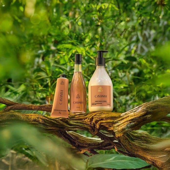Natura Ekos Castanha hand cream, body oil and body lotion on a tree branch in the forest