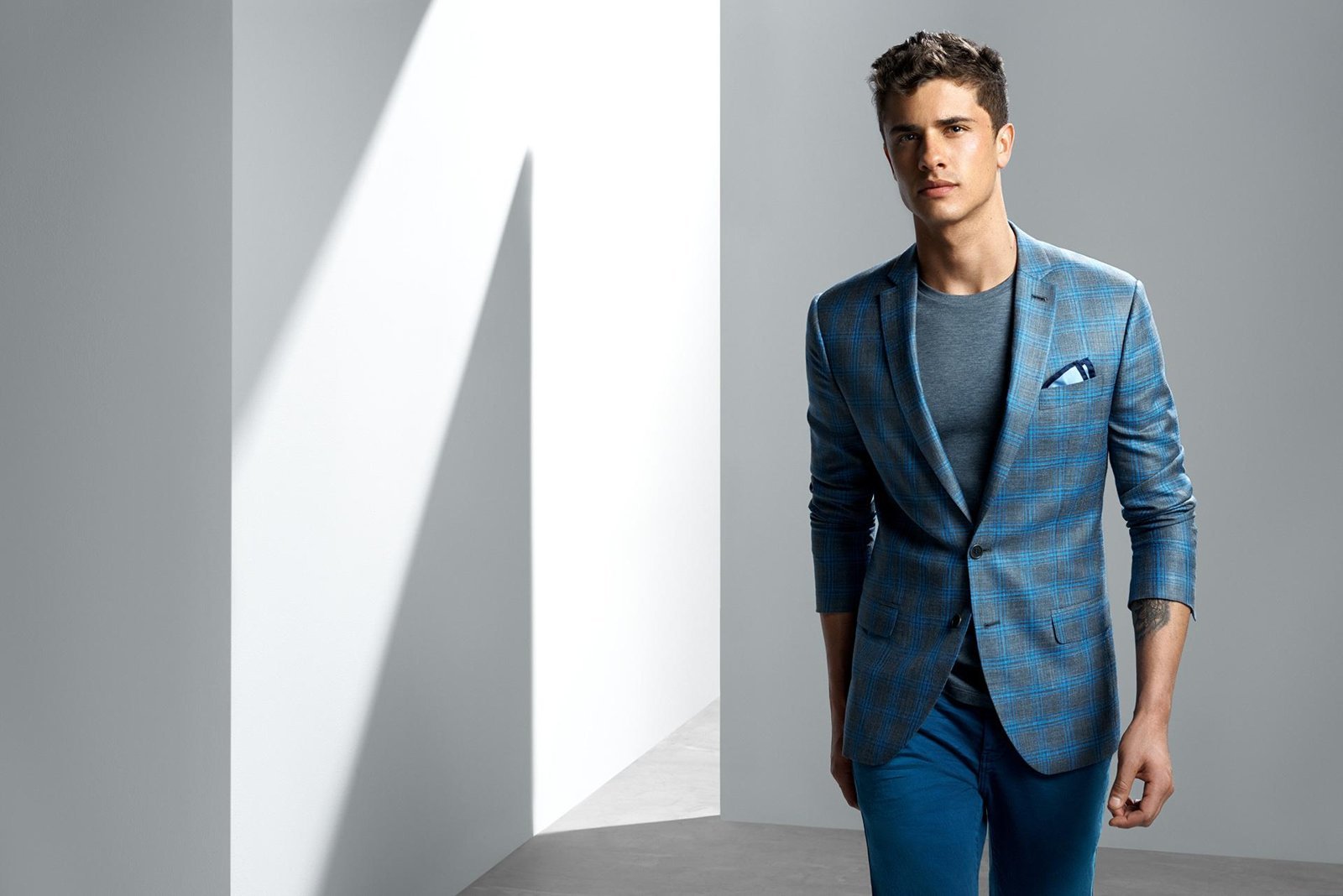 Man wearing a blue checked tailored jacket by Ricardo Almeida