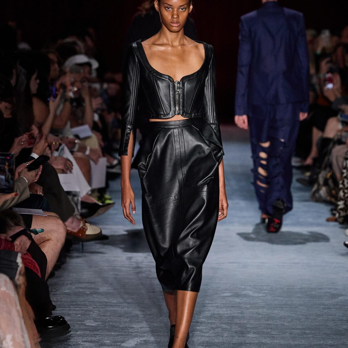 Model wearing a black leather corset top and midi skirt at the Herchcovitch;Alexandre show, SPFW N61