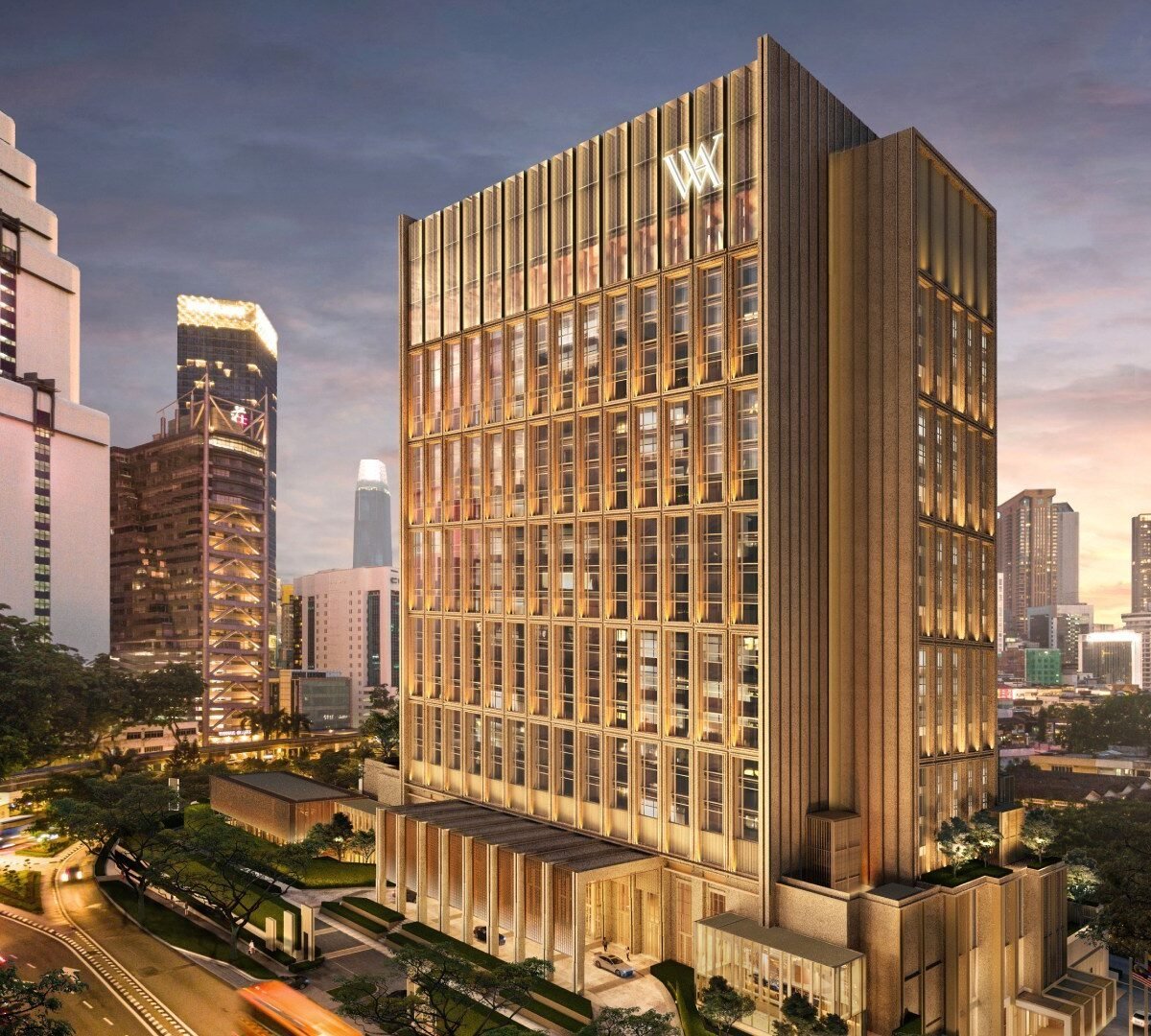 Fachada do Waldorf Astoria Kuala Lumpur iluminada ao entardecer