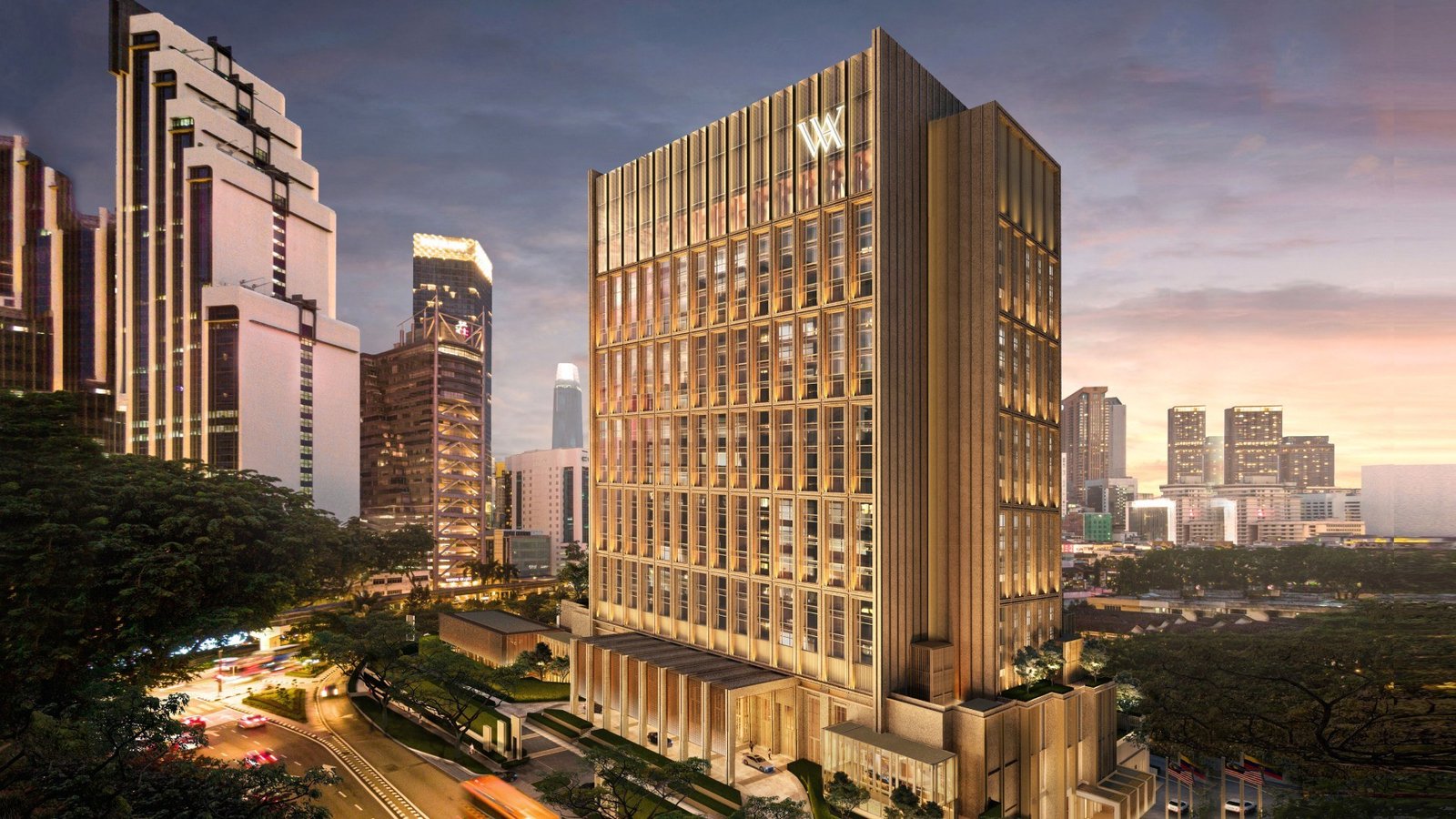 Fachada do Waldorf Astoria Kuala Lumpur iluminada ao entardecer